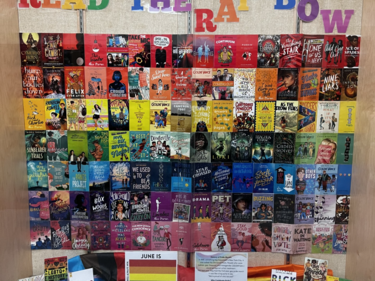 A variety of book covers put together to make the colour of the rainbow